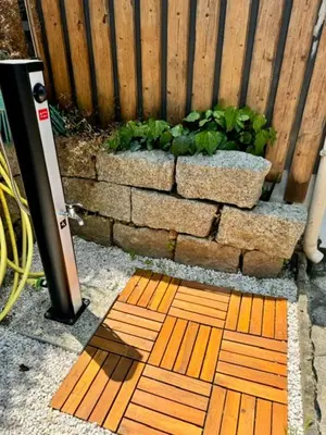 a wooden board on the ground in front of a fence at Maison avec jardin et proche mer in Propriano