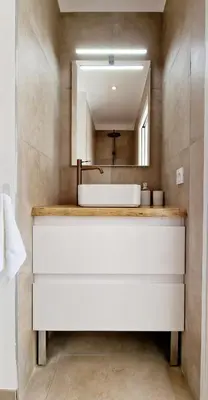 a bathroom with a white sink and a mirror at Villa neuve piscine privée chauffée Bonifacio in Bonifacio