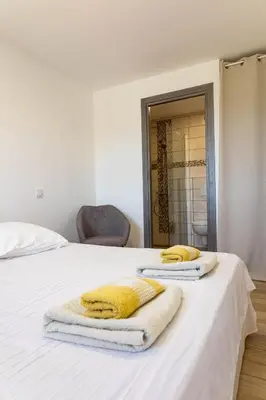 a bedroom with a bed with towels on it at Domaine de Campu in Vallecalle