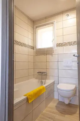 a bathroom with a tub and a toilet and a window at Domaine de Campu in Vallecalle