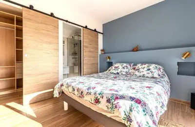 a bedroom with a bed with a floral bedspread at Villa ALTEA , au cœur du Maquis , 4 chambres , Figari in Figari