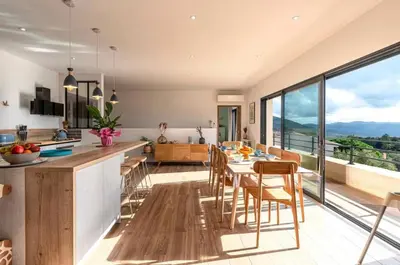 a kitchen and dining room with a table and chairs at Villa ALTEA , au cœur du Maquis , 4 chambres , Figari in Figari