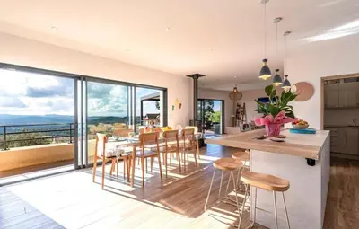 a kitchen and dining room with a table and chairs at Villa ALTEA , au cœur du Maquis , 4 chambres , Figari in Figari
