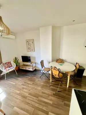 a living room with a table and chairs at Ajaccio centre ville joli T2 Grandval in Ajaccio