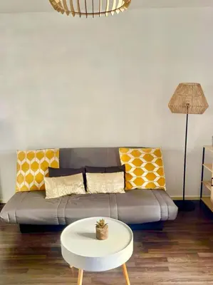 a living room with a couch and a table at Ajaccio centre ville joli T2 Grandval in Ajaccio