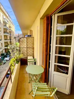 a small balcony with a table and chairs on it at Ajaccio centre ville joli T2 Grandval in Ajaccio