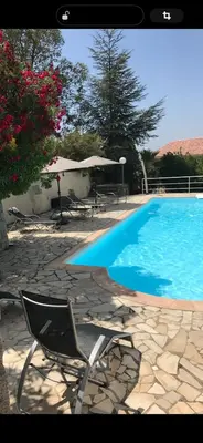 a blue swimming pool with a chair next to at Nouveau ! Villa avec piscine - Sainte-Marie-Siché in Santa-Maria-Siché