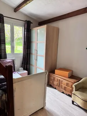 a bedroom with a bed and a chair and a window at Nouveau ! Villa avec piscine - Sainte-Marie-Siché in Santa-Maria-Siché