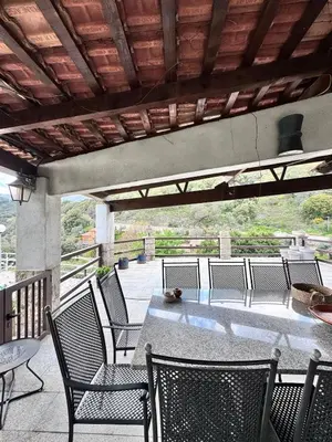 a patio with a table and chairs on a deck at Nouveau ! Villa avec piscine - Sainte-Marie-Siché in Santa-Maria-Siché