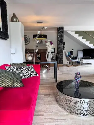 a living room with a red couch and a table at Nouveau ! Villa avec piscine - Sainte-Marie-Siché in Santa-Maria-Siché