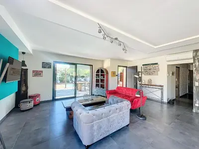 a living room with two couches and a red couch at Villa Macchia di Cervi in San-Gavino-di-Carbini