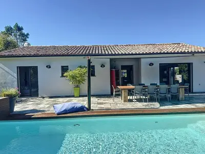 a house with a pool and a table and chairs at Villa Macchia di Cervi in San-Gavino-di-Carbini