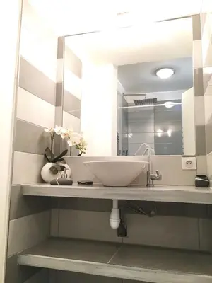 a bathroom with a sink and a mirror at Le Diodon De Sagone in Sagone
