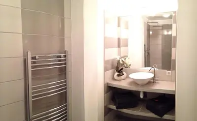 a bathroom with a sink and a mirror at Le Diodon De Sagone in Sagone