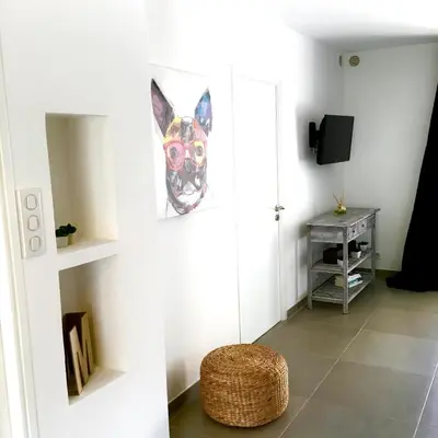 a living room with a dog picture on the wall at Le Diodon De Sagone in Sagone