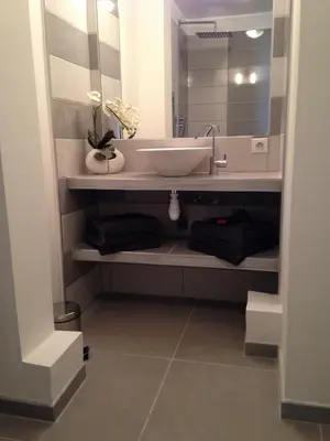 a bathroom with a sink and a mirror at Le Diodon De Sagone in Sagone