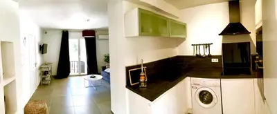 a kitchen with a washing machine in a room at Le Diodon De Sagone in Sagone