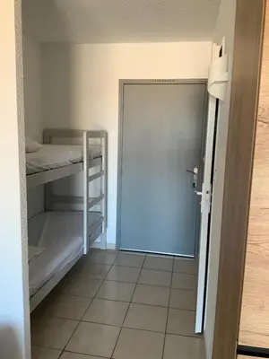 a room with two bunk beds and a door at Studio Face à la mer in Cervione