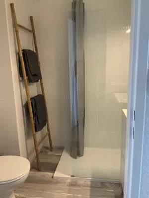 a bathroom with a toilet and a glass shower at Studio Face à la mer in Cervione