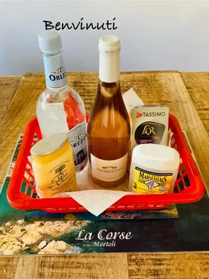 a tray with a bottle of sauce and other ingredients at Villa de bord de plage in Pinarellu