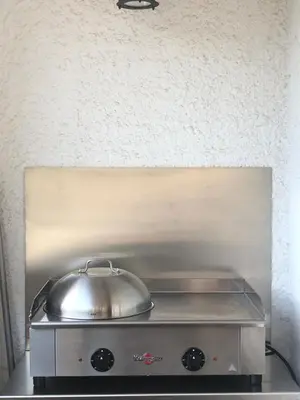 a silver pot sitting on top of a stove at F2 tout confort, les pieds dans l'eau, PORTICCIO in Grosseto-Prugna