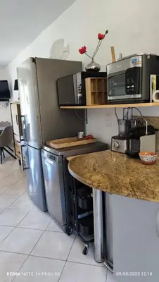 a kitchen with stainless steel appliances and a counter at F2 tout confort, les pieds dans l'eau, PORTICCIO in Grosseto-Prugna