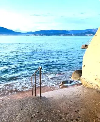 a view of a body of water with the ocean at F2 tout confort, les pieds dans l'eau, PORTICCIO in Grosseto-Prugna
