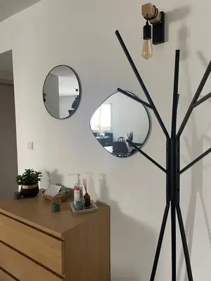 a mirror on a wall next to a dresser at Mini villa,, 700 m de la plage à pieds in Pinarellu