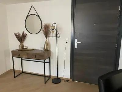 a mirror on a table next to a door at Appartement T3, 5 minutes à pied des plages in Ajaccio