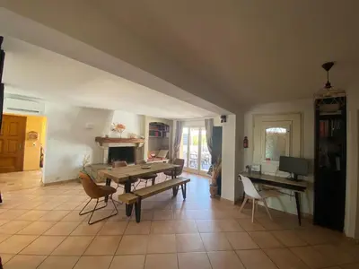 a living room with a table and a fireplace at villa a calata in Porto-Vecchio