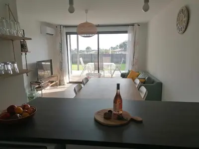 a bottle of wine on a table in a living room at Porticcio grand appartement 3 pièces, 5 minutes de la plage in Porticcio
