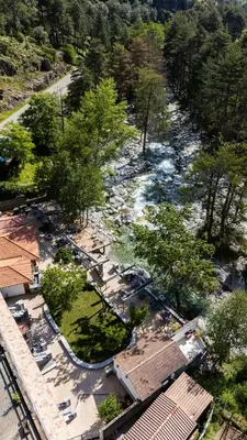 an aerial view of a river with buildings and trees at Hotel Arena le Refuge in Corte