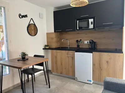a kitchen with a table and a sink and a microwave at Alizo in Lecci