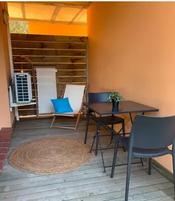 a patio with two tables and chairs and a rug at Alizo in Lecci
