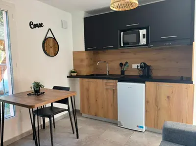 a kitchen with a table and a sink and a microwave at Alizo in Lecci