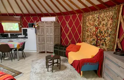 a room with a bed and a kitchen in a tent at yourte de luxe contemporaine in Bonifacio