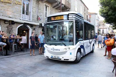 a white bus is parked on a city street at APPARTEMENT T3 65 m2 CENTRE VILLE in Porto-Vecchio