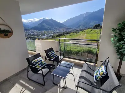 a balcony with chairs and a view of mountains at Charmant t2 avec terrasse in Corte