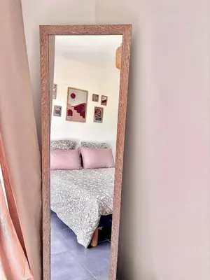 a mirror reflecting a bedroom with a bed in a room at Charmant t2 avec terrasse in Corte