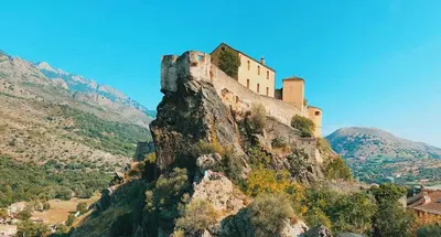 a castle perched on top of a mountain at Charmant t2 avec terrasse in Corte
