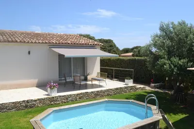 a swimming pool in the backyard of a house at Casa EliaEmie Bonifacio in Bonifacio