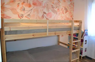 a bunk bed in a room with a wall at Casa EliaEmie Bonifacio in Bonifacio