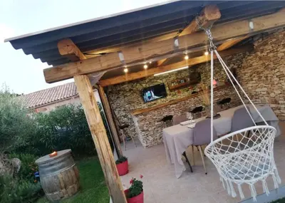 a patio with a table and a swing at Casa EliaEmie Bonifacio in Bonifacio