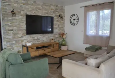 a living room with a flat screen tv on a brick wall at Casa EliaEmie Bonifacio in Bonifacio