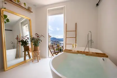 a bathroom with a tub and a large mirror at Sublime, hyper-centre d'Ajaccio, avec Spa, Sauna, Vue mer & Plage à 3min in Ajaccio