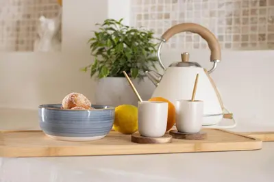 a wooden cutting board with a tea kettle and lemons at Sublime, hyper-centre d'Ajaccio, avec Spa, Sauna, Vue mer & Plage à 3min in Ajaccio