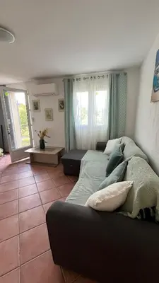 a living room with a large bed and a couch at Le Gozzi in Afa
