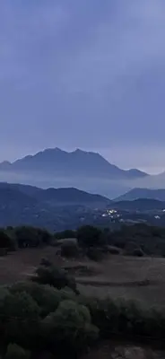 a view of a field with mountains in the distance at Le Gozzi in Afa