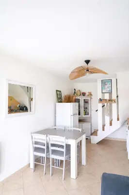 a kitchen with a table and a dining room at Maison calme au bord de l'eau in Lucciana
