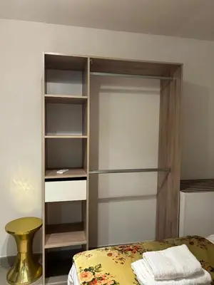 a bedroom with a bed and a book shelf at Casa CARLU-MARIA IV in Corte